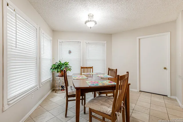 a view of a dining room with furniture and window