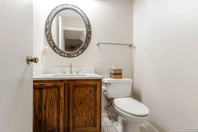 a bathroom with a toilet sink and mirror