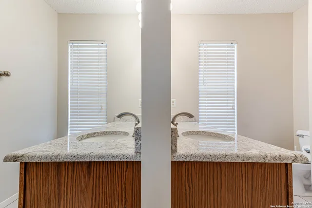 a bathroom with a granite countertop and sink