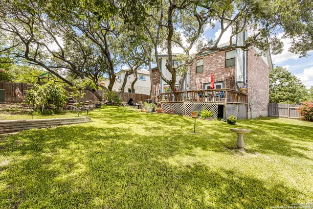 a backyard of a house with large trees