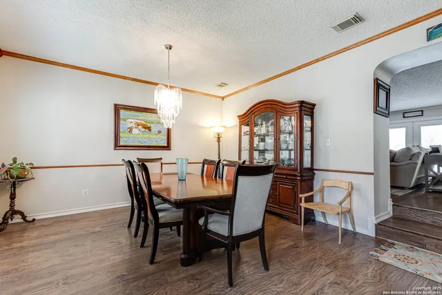 a dining room with furniture a rug and wooden floor