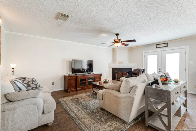 a living room with furniture a flat screen tv and a fireplace