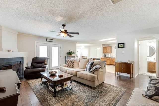 a living room with furniture a fireplace and a window