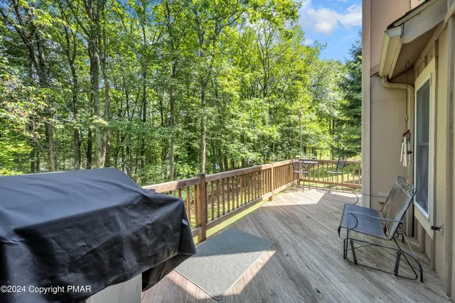 a view of balcony with wooden floor and outdoor seating
