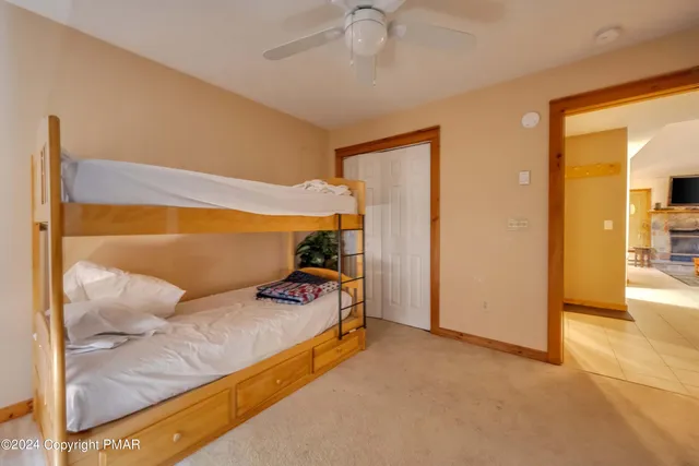 a bedroom with furniture and a ceiling fan