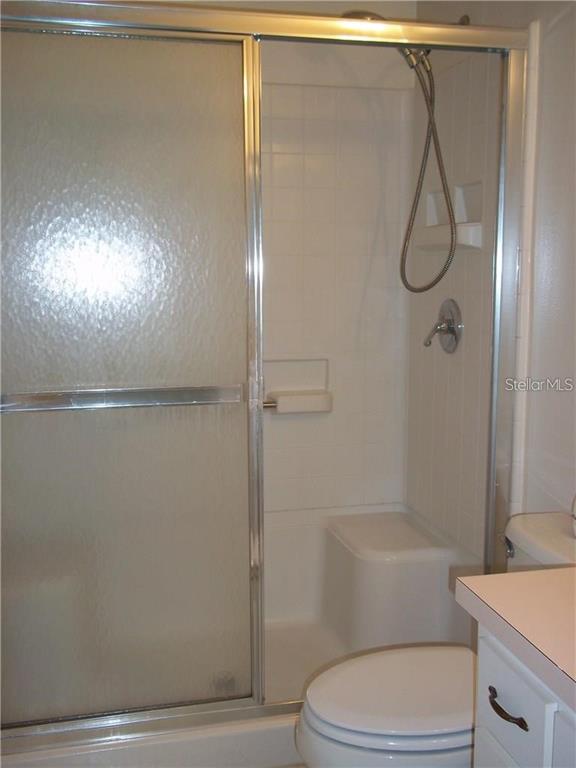 2464 Nantucket Harbor Loop, Unit 96 Sun City Center, FL 33573 - Photo 14 of 19 a bathroom with a toilet and shower