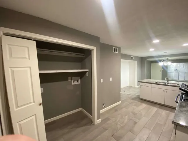 a large white kitchen with a sink