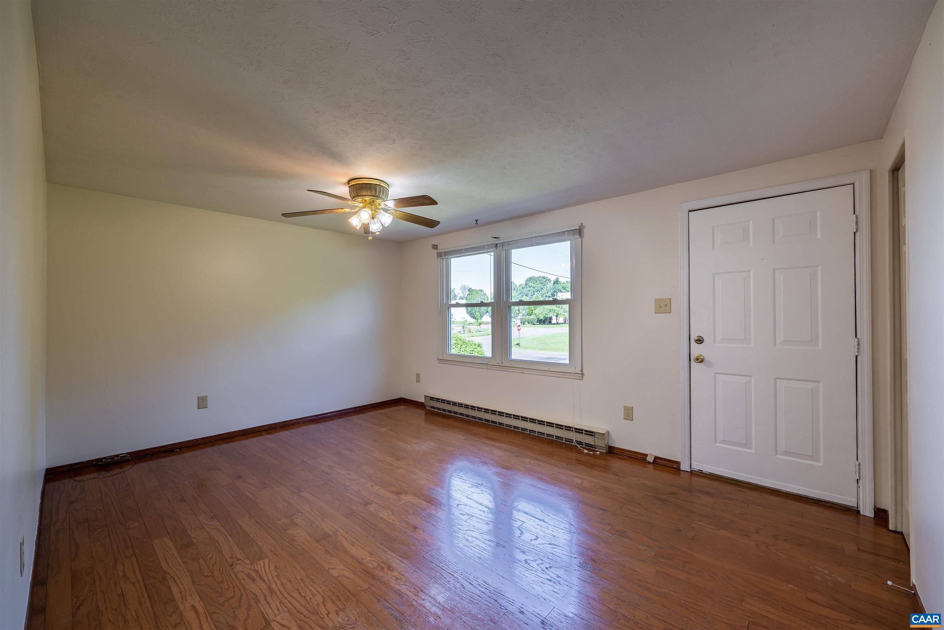 22 Rucker Drive Ruckersville, VA 22968 - Photo 3 of 26 an empty room with wooden floor chandelier fan and windows