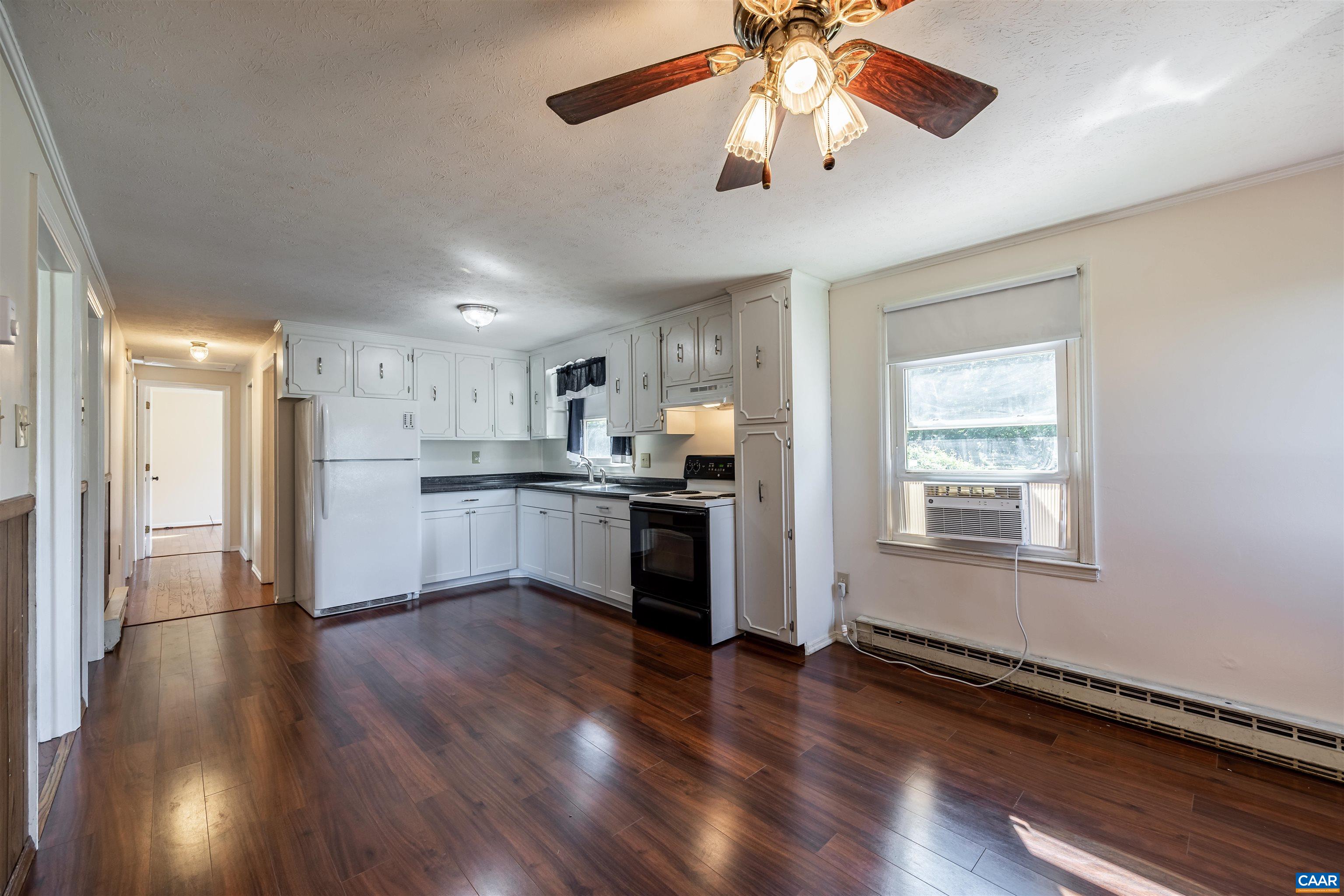 22 Rucker Drive Ruckersville, VA 22968 - Photo 7 of 26 a view of an empty room and kitchen with wooden floor
