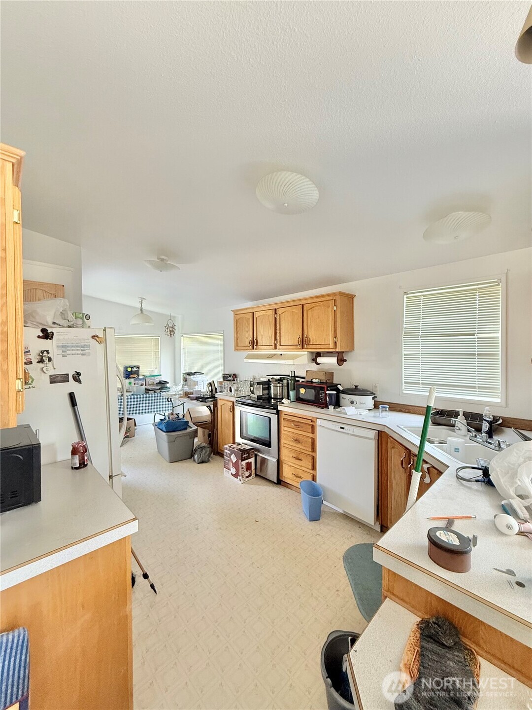84 Weatherstone Road Omak, WA 98841 - Photo 7 of 17 a kitchen with stainless steel appliances kitchen island granite countertop a sink and cabinets