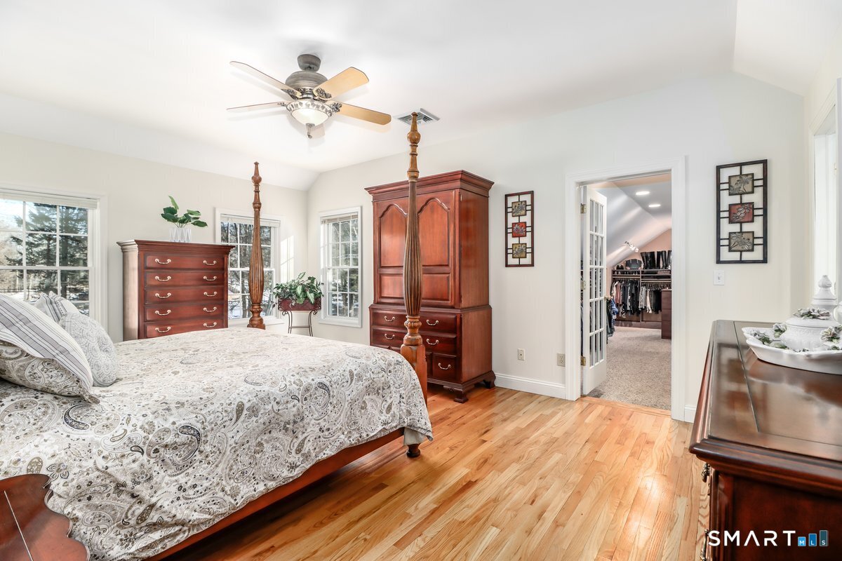 427 Long Mountain Road New Milford, CT 06776 - Photo 19 of 40 a bedroom with a bed dresser and wooden floor