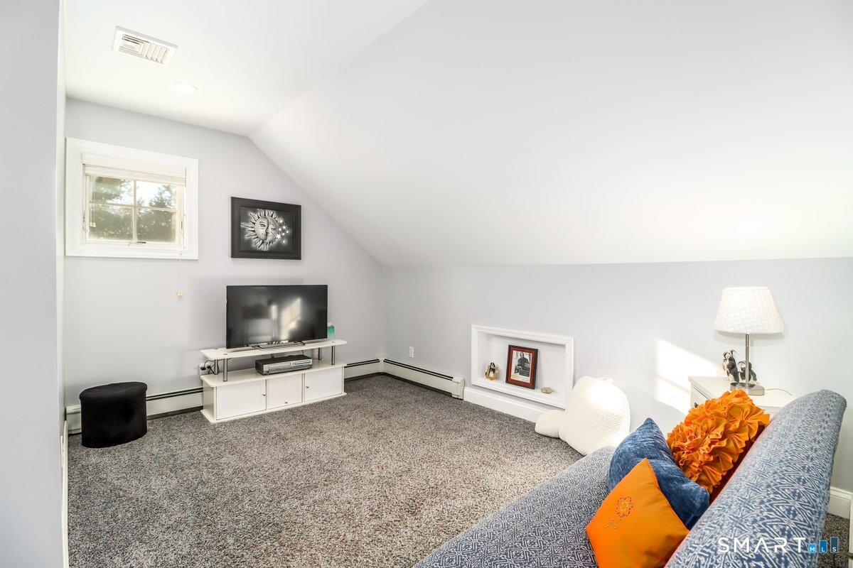 427 Long Mountain Road New Milford, CT 06776 - Photo 25 of 40 a living room with furniture and a flat screen tv