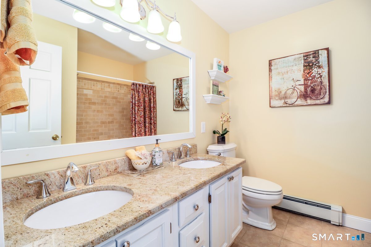 427 Long Mountain Road New Milford, CT 06776 - Photo 27 of 40 a bathroom with a granite countertop sink a toilet and a mirror