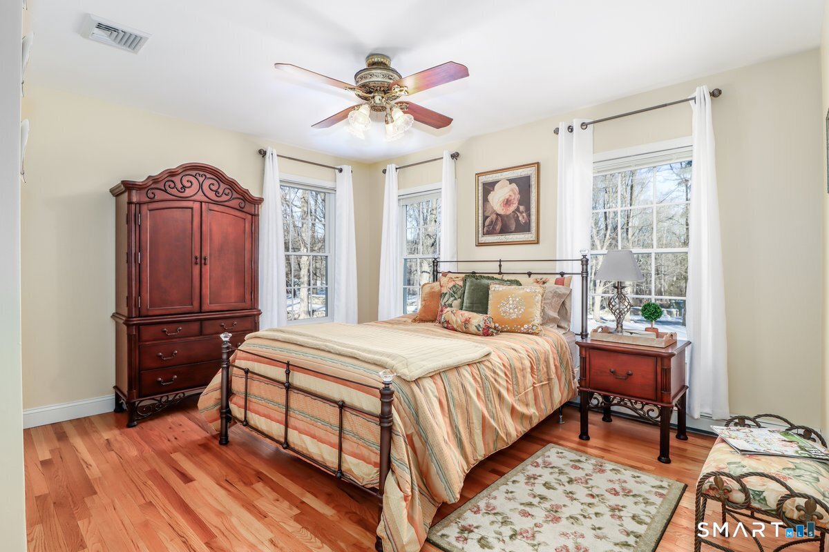 427 Long Mountain Road New Milford, CT 06776 - Photo 28 of 40 a bedroom with a bed and wooden floor