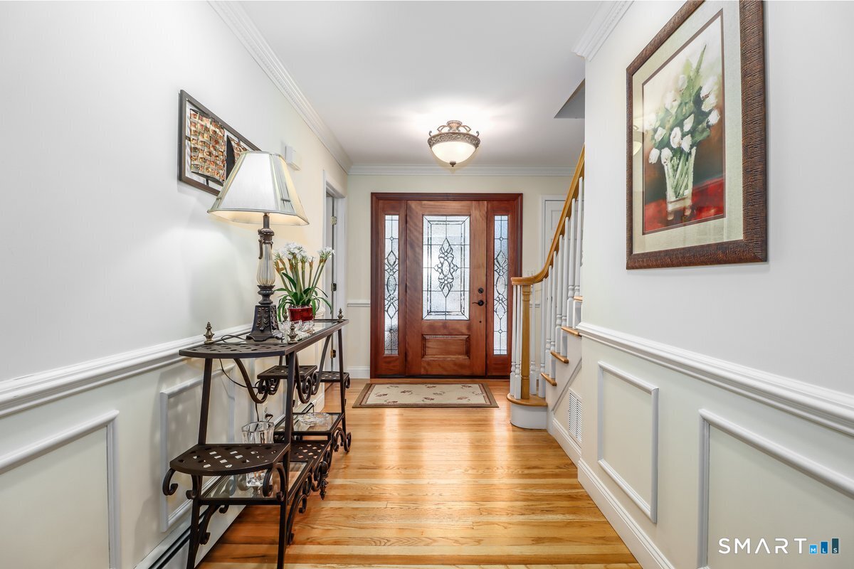 427 Long Mountain Road New Milford, CT 06776 - Photo 4 of 40 a view of a hallway with wooden floor and furniture