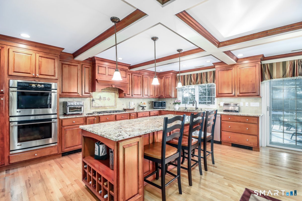 427 Long Mountain Road New Milford, CT 06776 - Photo 5 of 40 a kitchen with stainless steel appliances granite countertop a stove top oven a sink dishwasher and a microwave oven on the wooden floor