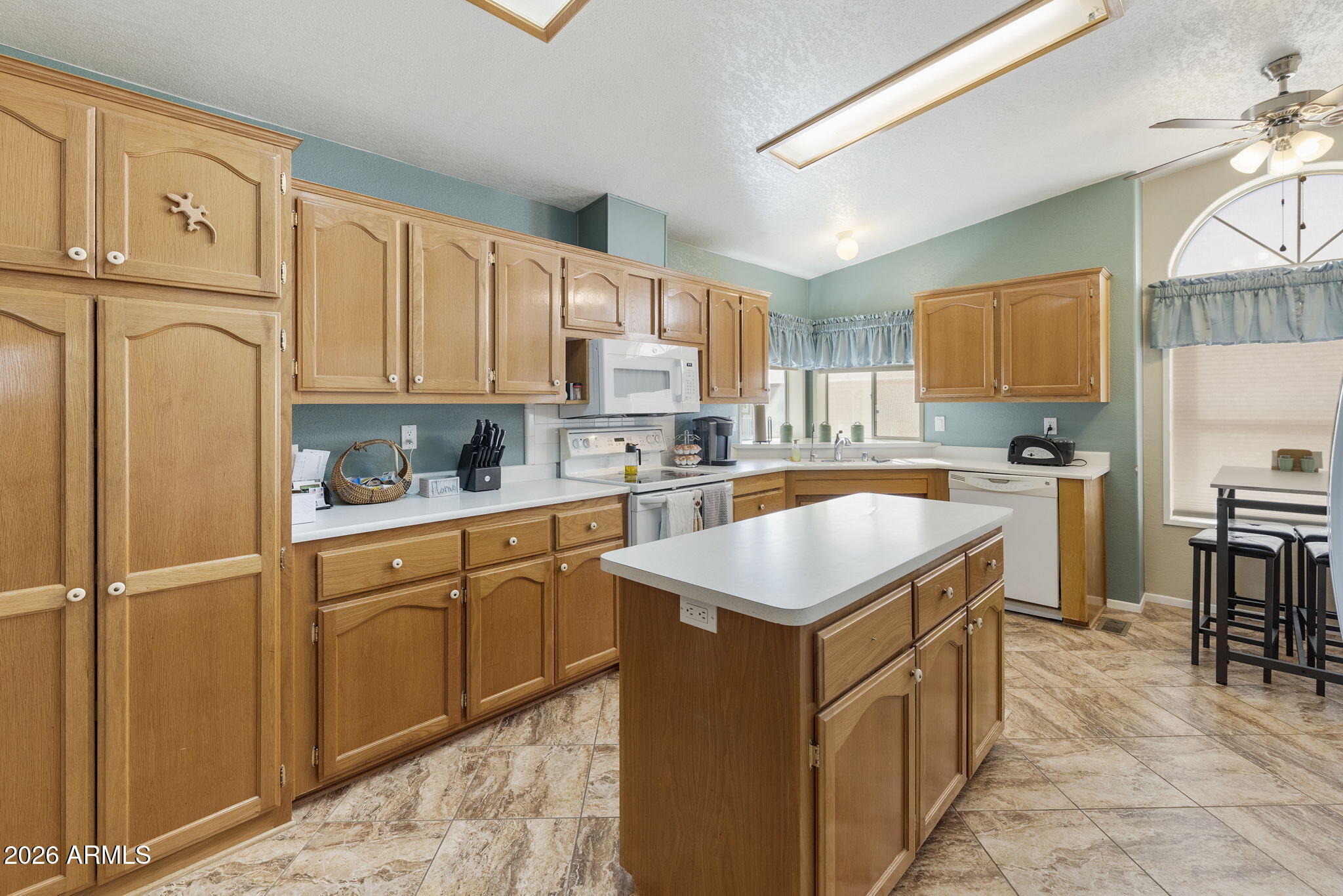 3700 South Tomahawk Road, Unit 23 Apache Junction, AZ 85119 - Photo 31 of 31 a kitchen with kitchen island granite countertop a sink a counter top space and stainless steel appliances