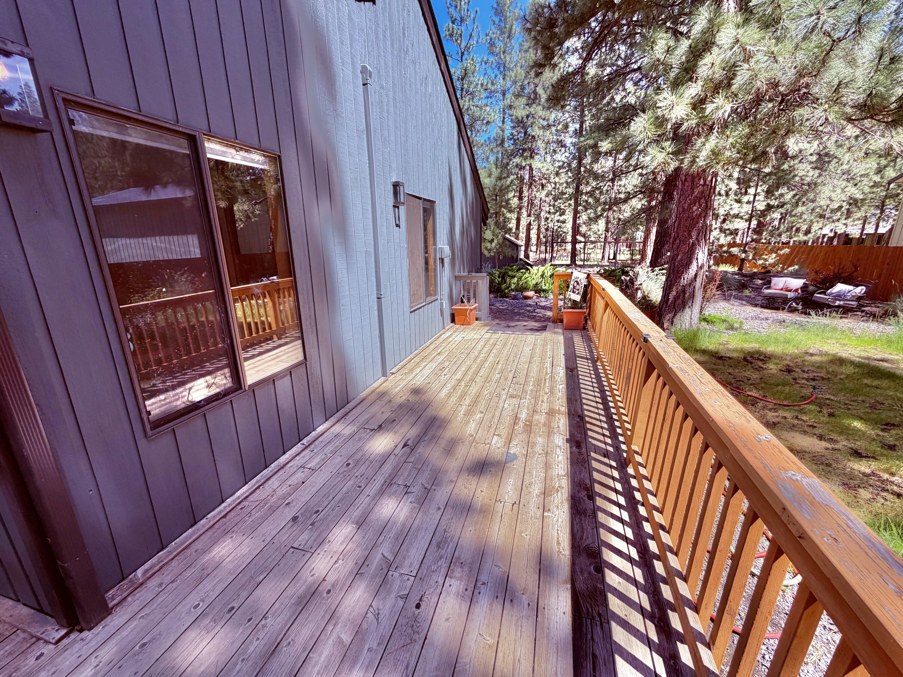 68964 Graham Court Sisters, OR 97759 - Photo 3 of 28 a view of balcony with wooden floor and fence
