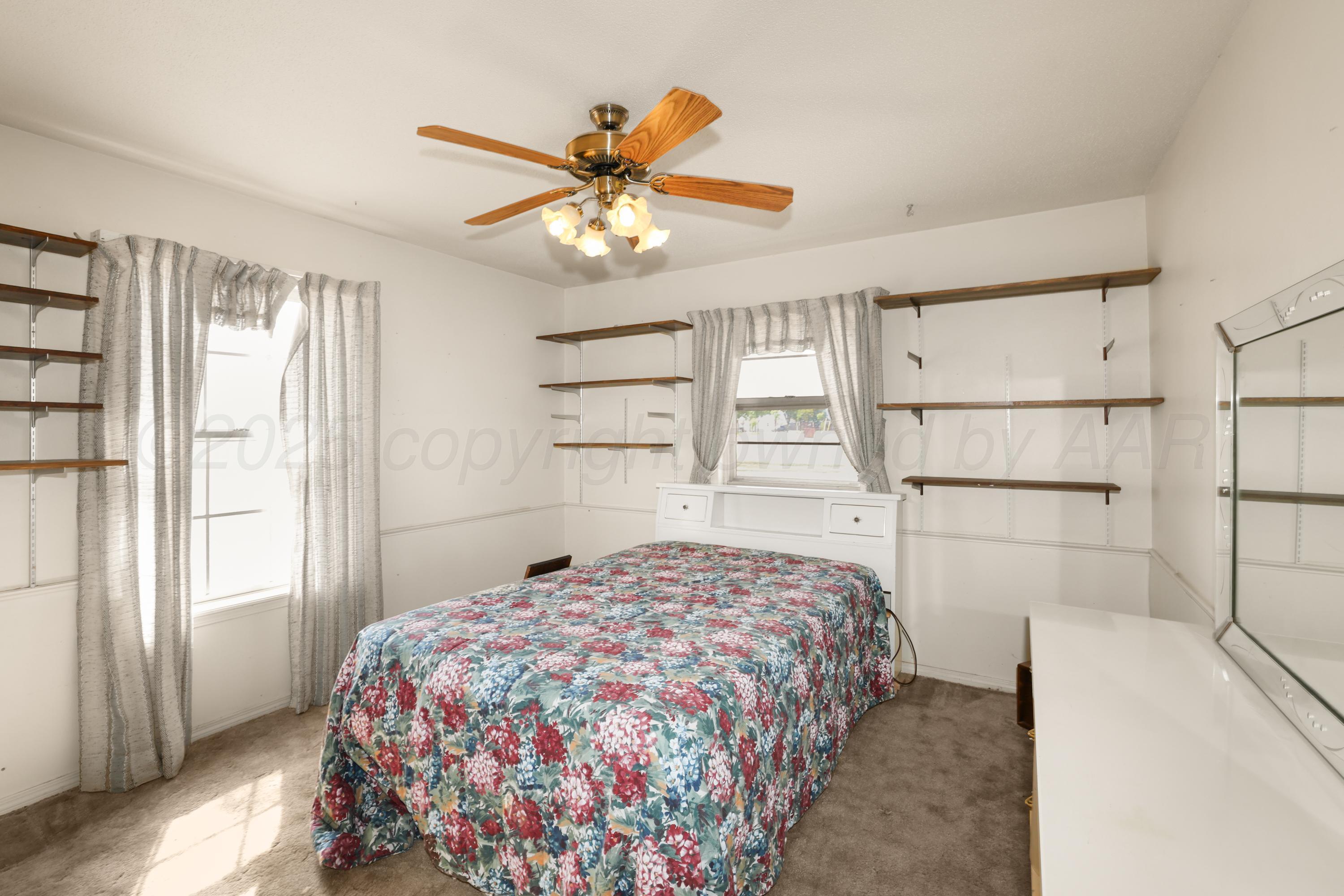 7682 Back Acres Road Amarillo, TX 79119 - Photo 14 of 27 a bedroom with a bed and a window