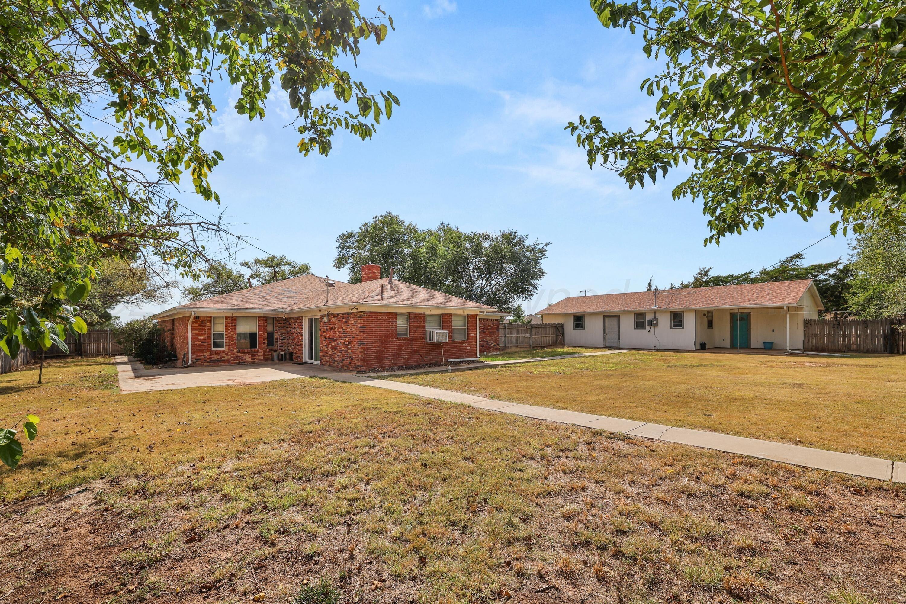 7682 Back Acres Road Amarillo, TX 79119 - Photo 17 of 27 a front view of a house with a yard and trees