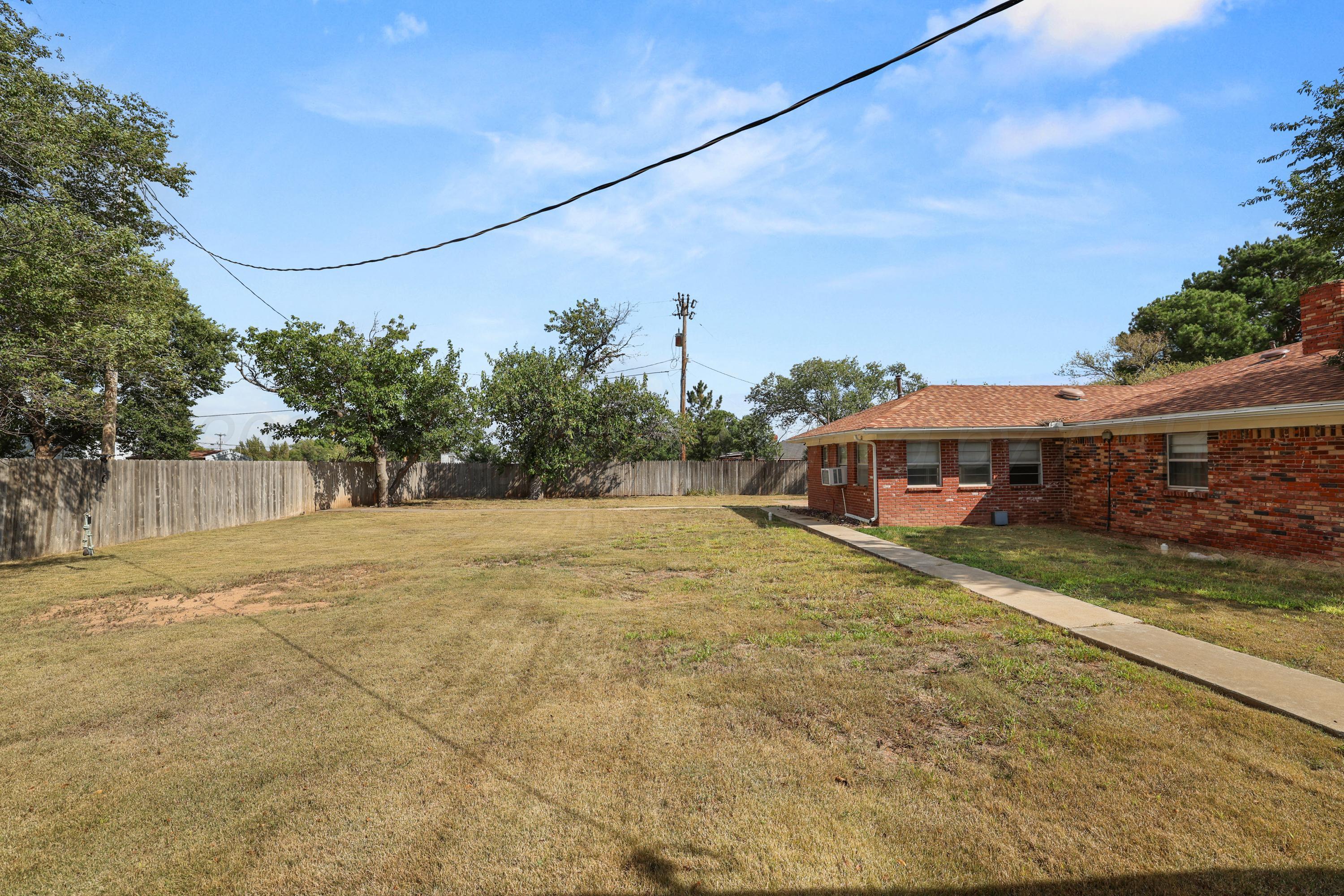 7682 Back Acres Road Amarillo, TX 79119 - Photo 18 of 27 a view of a house with a yard