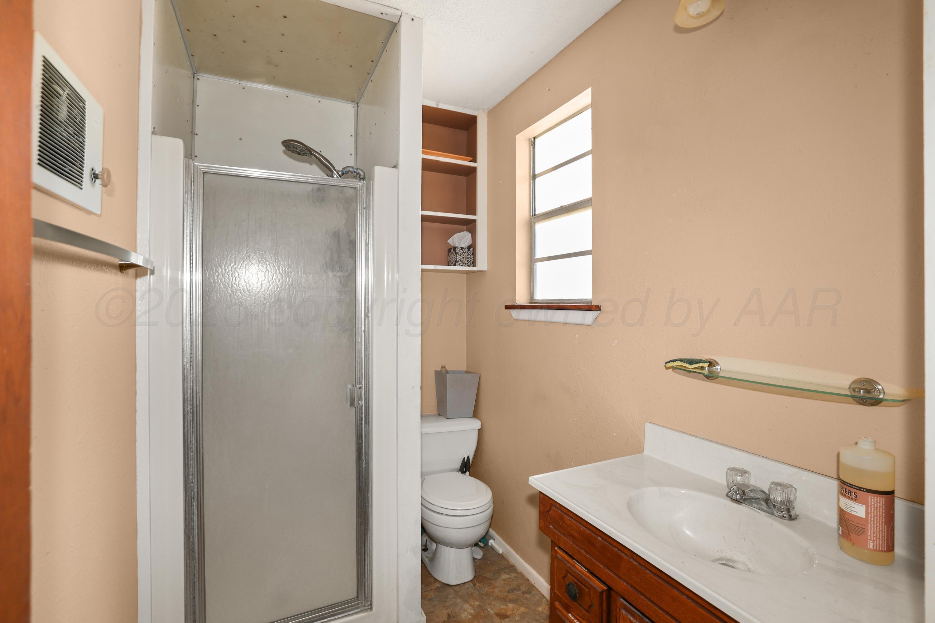 7682 Back Acres Road Amarillo, TX 79119 - Photo 24 of 27 a bathroom with a sink toilet and shower