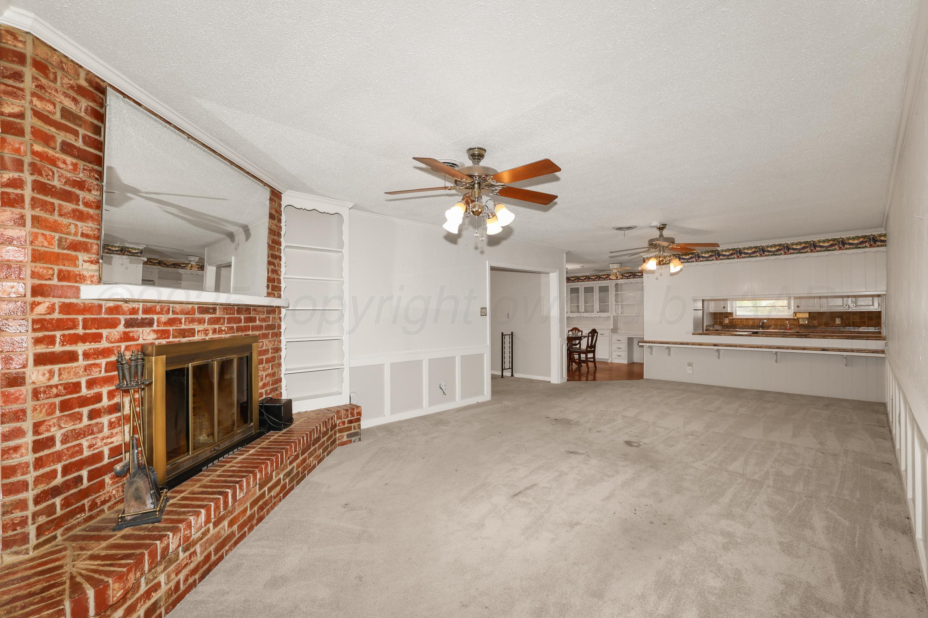 7682 Back Acres Road Amarillo, TX 79119 - Photo 4 of 27 a living room with furniture and a fireplace