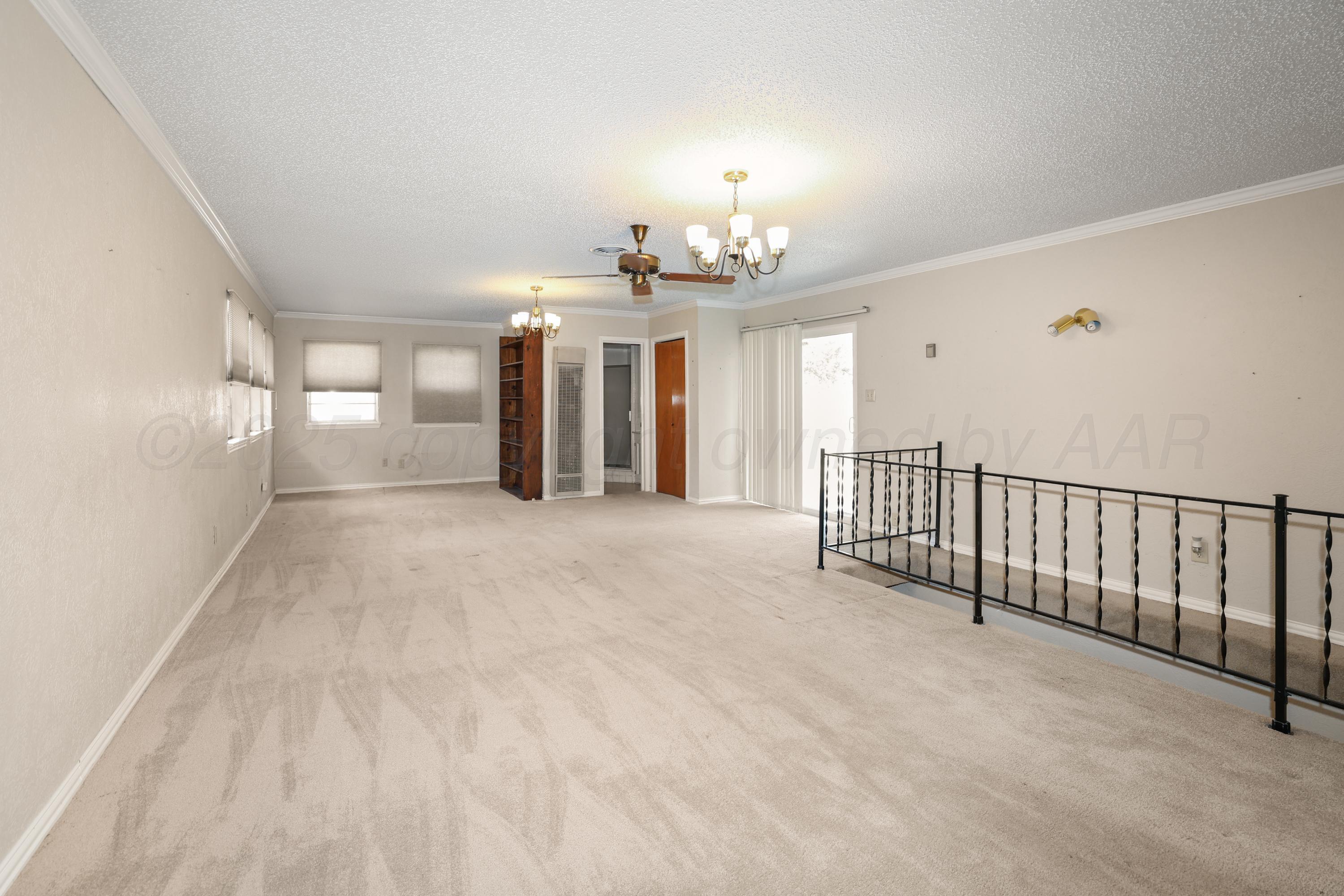 7682 Back Acres Road Amarillo, TX 79119 - Photo 7 of 27 a view of a hallway with chandelier