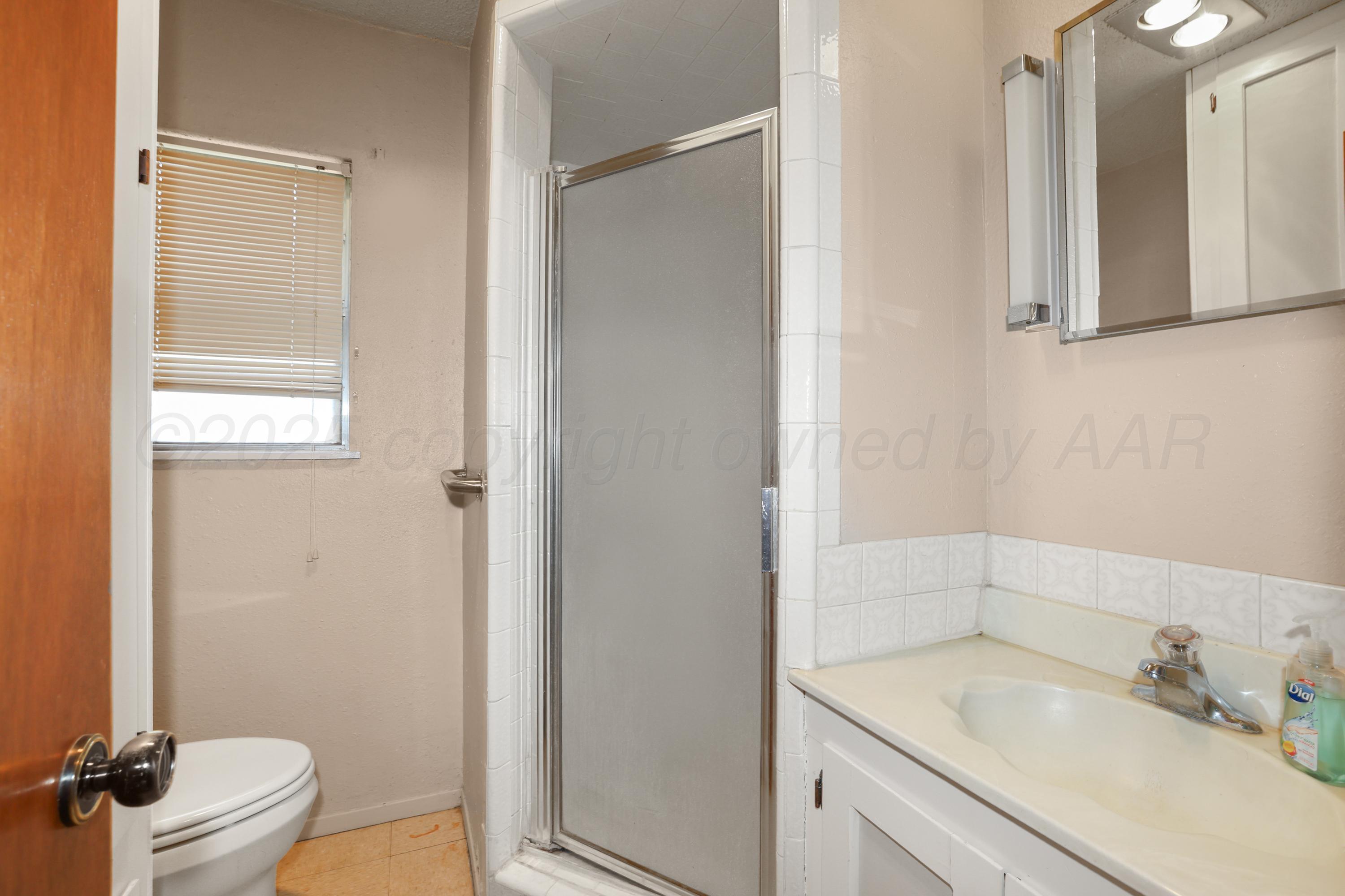 7682 Back Acres Road Amarillo, TX 79119 - Photo 8 of 27 a bathroom with a sink toilet and shower