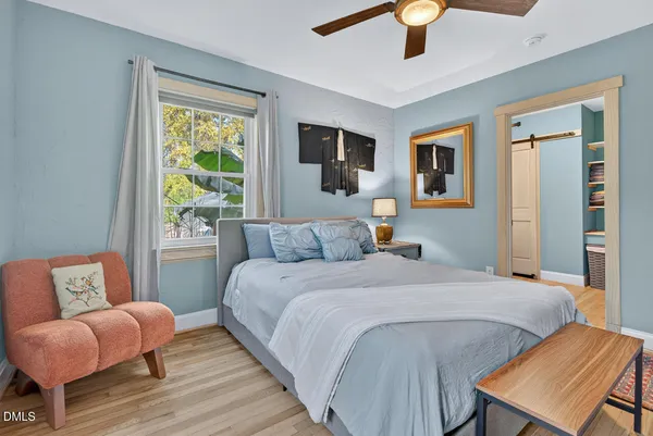 a bedroom with a bed and wooden floor