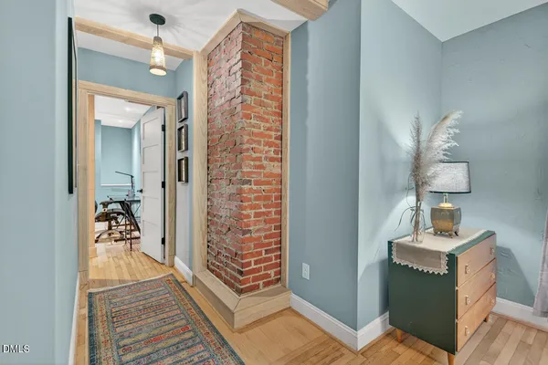 a view of a hallway a bedroom and wooden floor