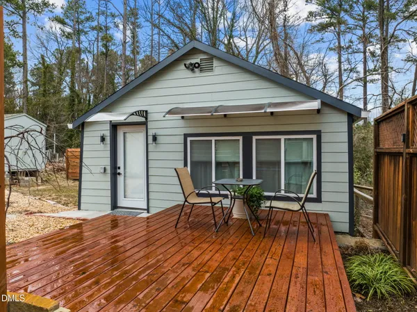 a view of house with deck and outdoor seating