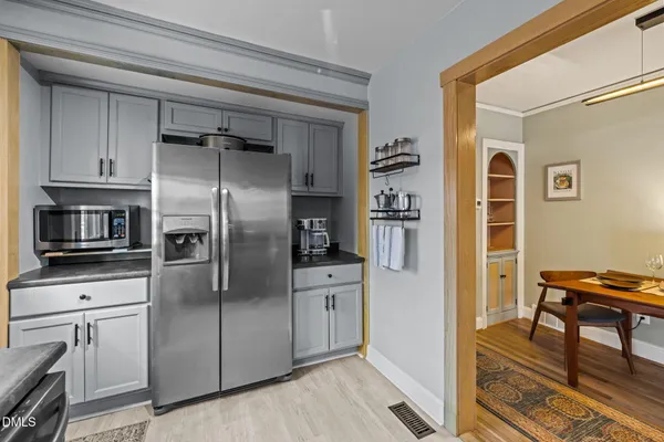 a kitchen with stainless steel appliances a refrigerator and a stove top oven