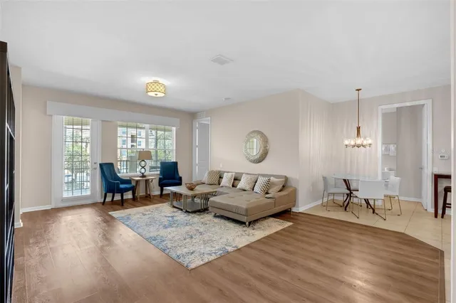 a living room with furniture and a wooden floor