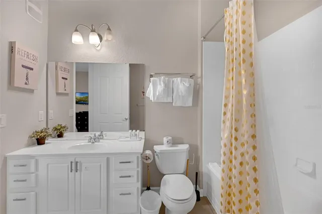 a bathroom with a shower curtain and a window