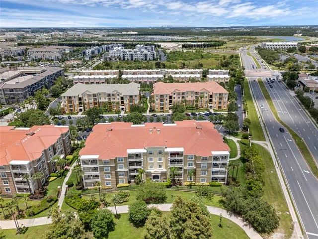 an aerial view of residential houses with outdoor space and swimming pool