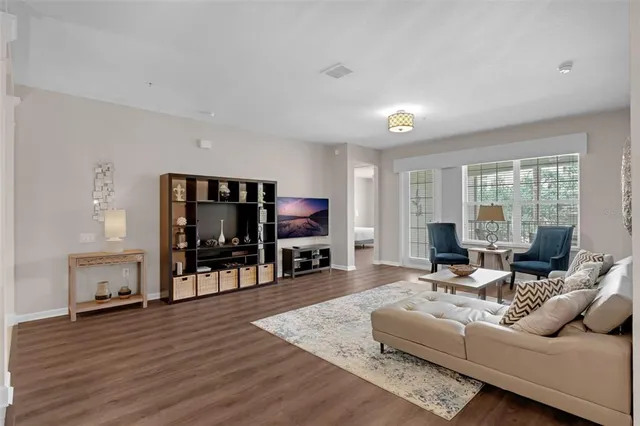 a living room with furniture and a large window