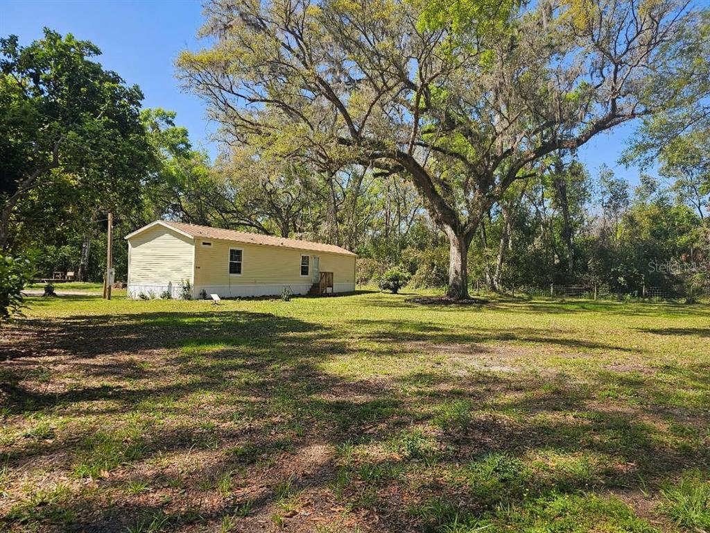 36816 Indian Lake Cemetery Road Dade City, FL 33523 - Photo 1 of 1 a front view of a house with a yard