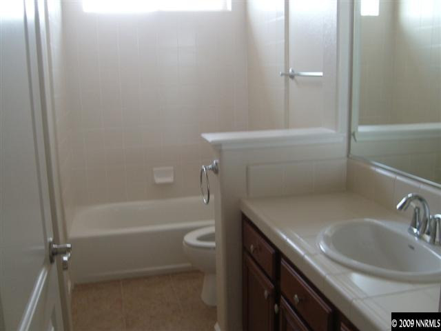 10075 Bull Rider Court Reno, NV 89521 - Photo 8 of 9 a bathroom with a sink a toilet and shower