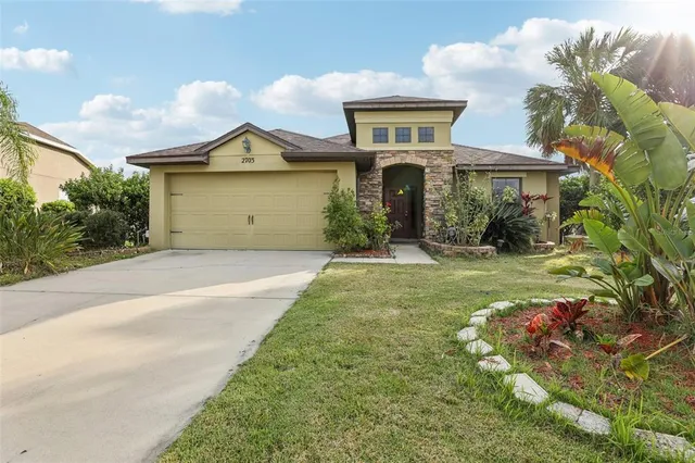 a front view of a house with a yard and garage