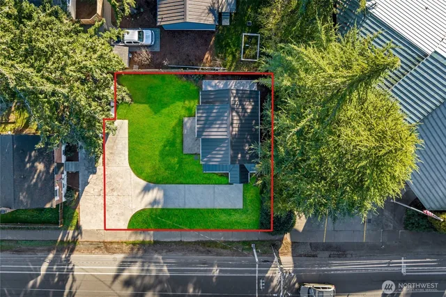 an aerial view of a house with a garden and swimming pool