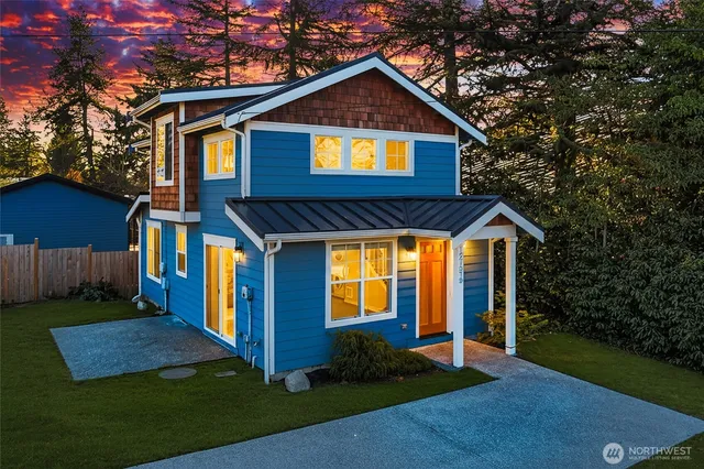 a front view of a house with yard and green space