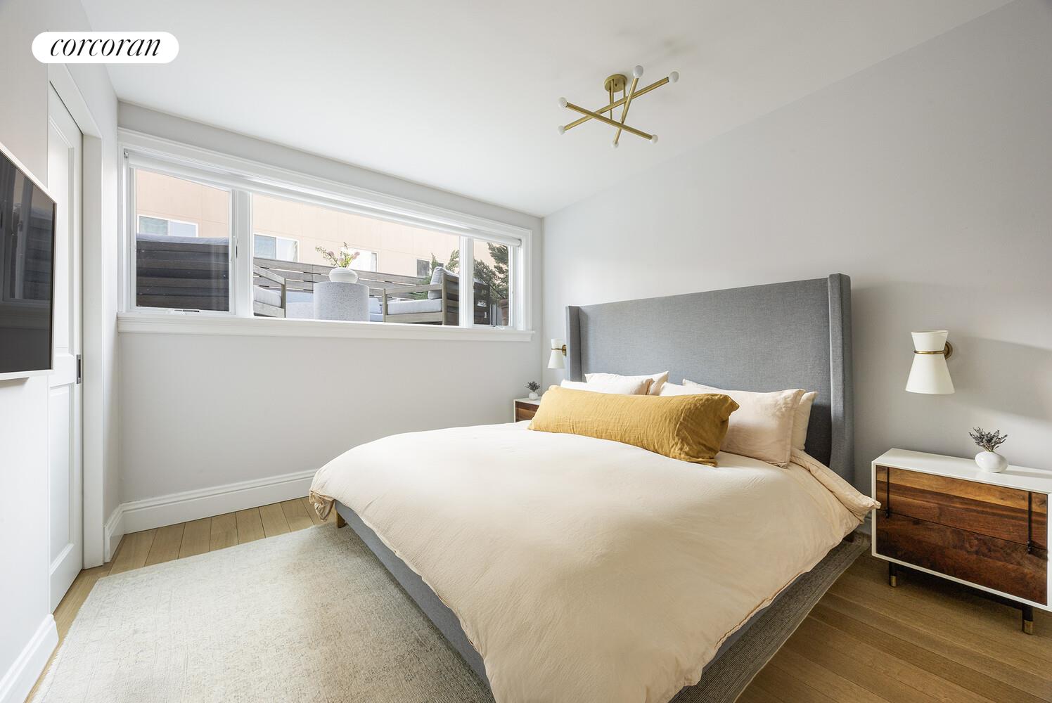 80 Leonard Street, Unit 5H Manhattan, NY 10013 - Photo 10 of 15 a bedroom with a bed and a window