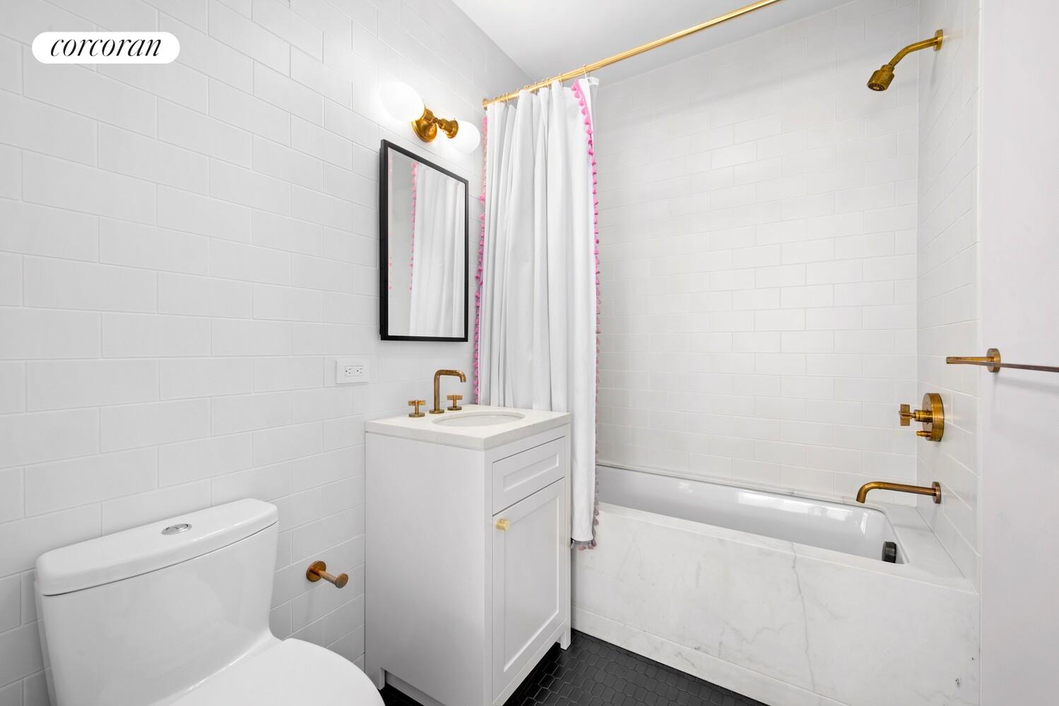 80 Leonard Street, Unit 5H Manhattan, NY 10013 - Photo 13 of 15 a bathroom with a sink a toilet and shower