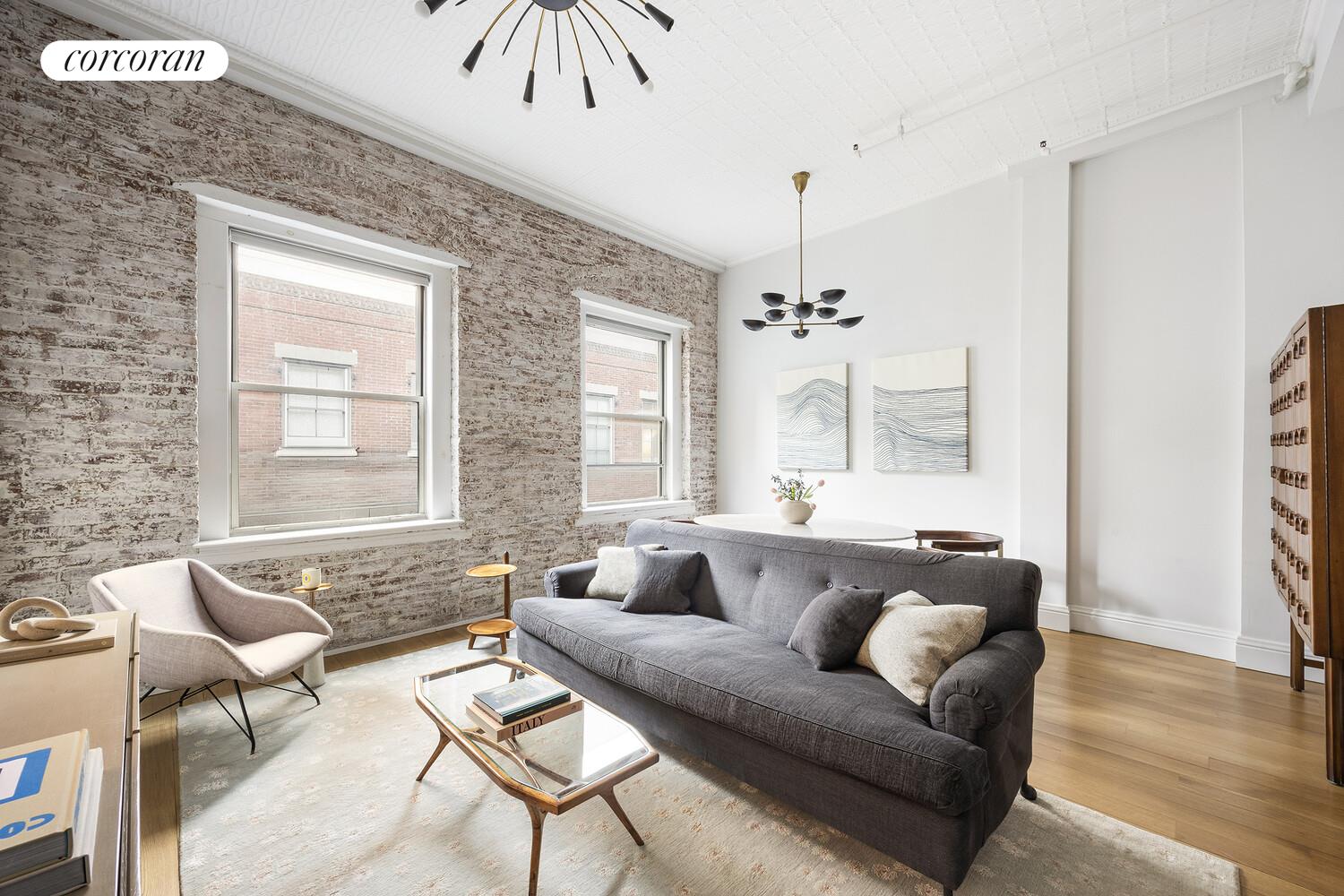 80 Leonard Street, Unit 5H Manhattan, NY 10013 - Photo 2 of 15 a living room with furniture and a large window