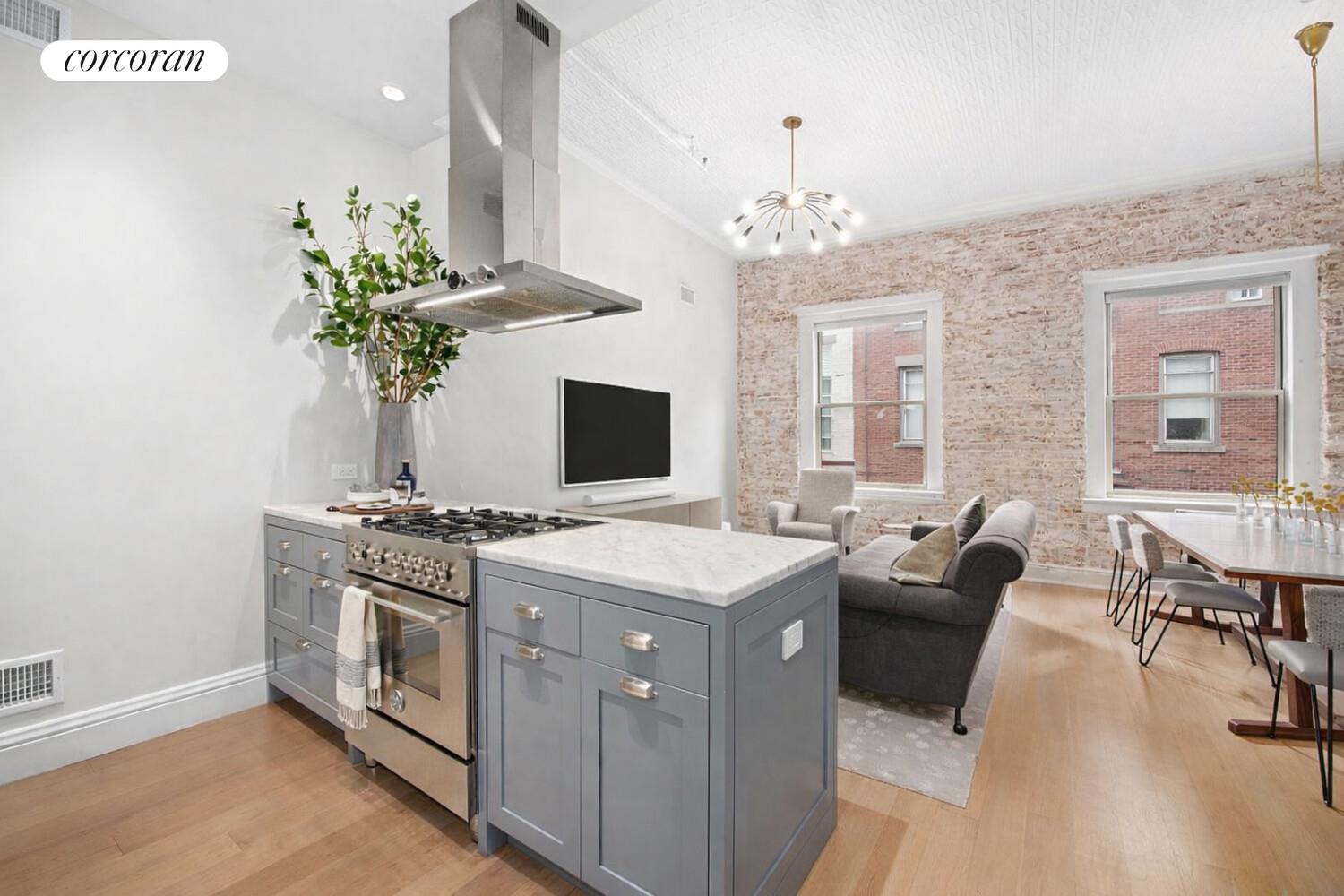 80 Leonard Street, Unit 5H Manhattan, NY 10013 - Photo 3 of 15 a view of a dining room with furniture a chandelier and wooden floor