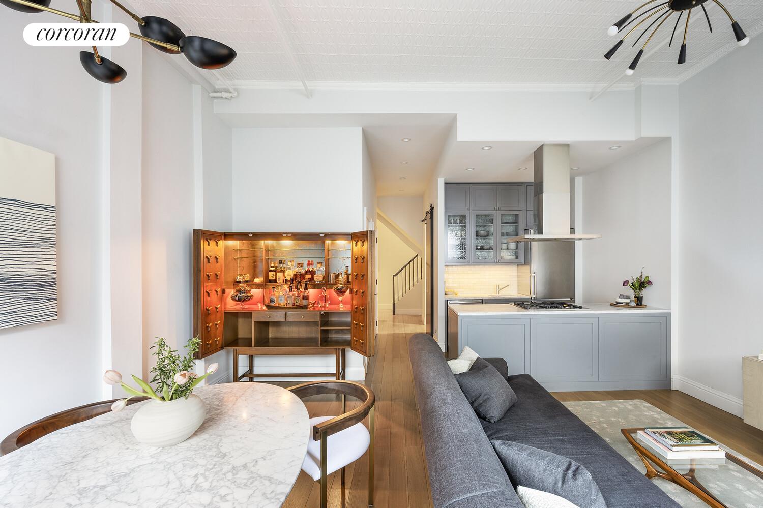 80 Leonard Street, Unit 5H Manhattan, NY 10013 - Photo 5 of 15 a living room with furniture and a flat screen tv
