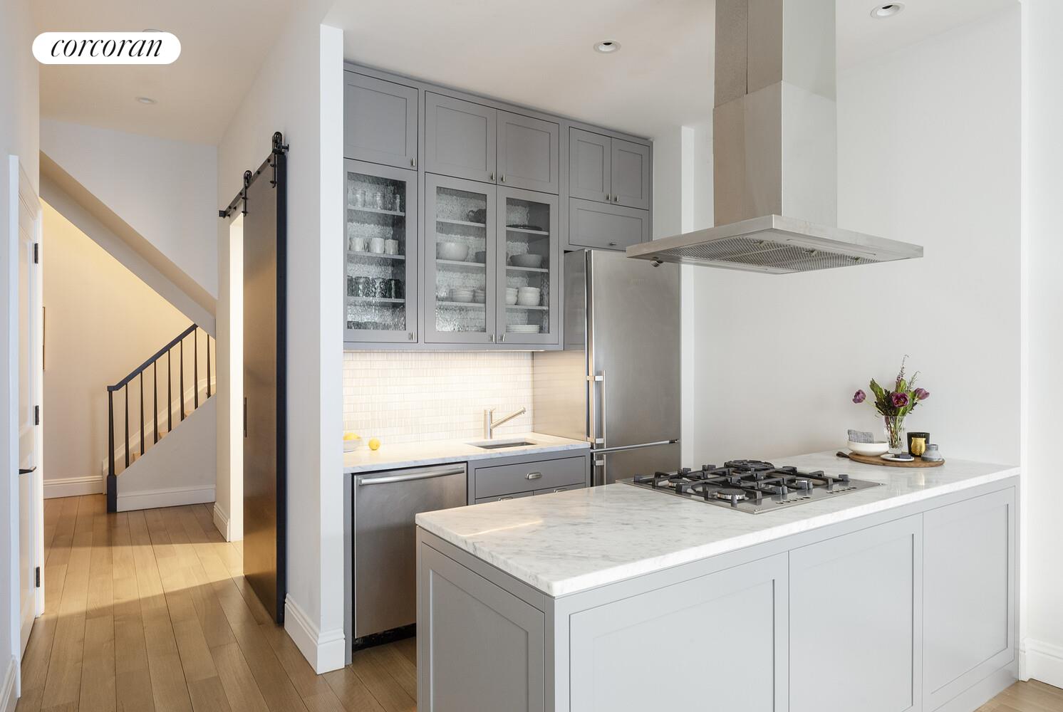 80 Leonard Street, Unit 5H Manhattan, NY 10013 - Photo 6 of 15 a kitchen with a sink a stove and a refrigerator