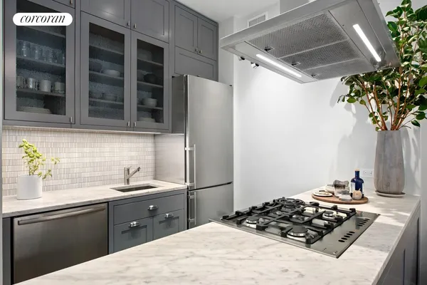a kitchen with a sink a stove and a refrigerator