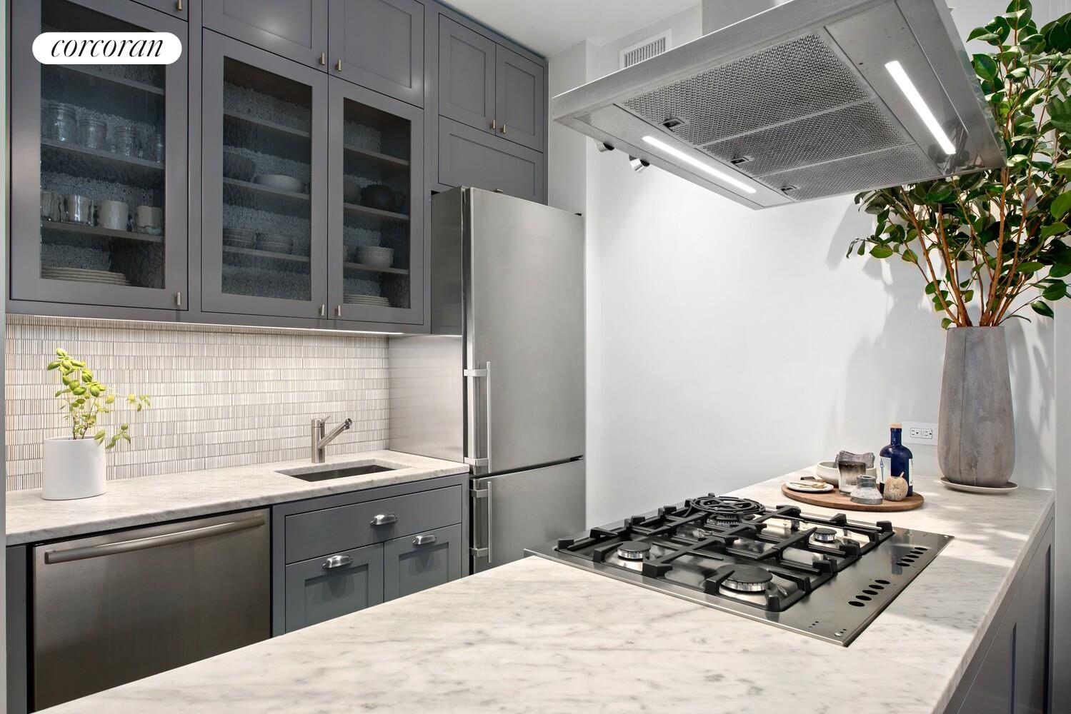 80 Leonard Street, Unit 5H Manhattan, NY 10013 - Photo 7 of 15 a kitchen with stainless steel appliances kitchen island granite countertop a refrigerator and a sink